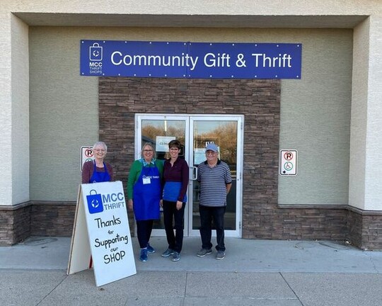 Four volunteers standing outside Gift & Thrift shop.