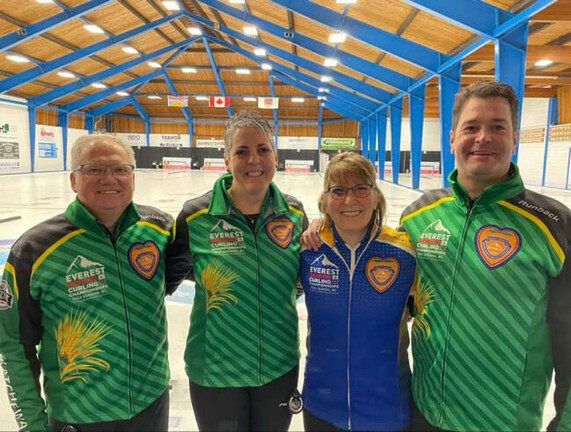 Group photo of four curlers with smiles.