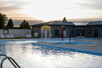 Splash feature running in pool, shot at dusk.