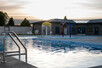 Splash feature running in pool, shot at dusk.