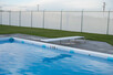 Diving board in pool.