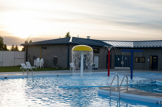 Splash feature running in pool, shot at dusk.