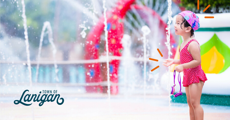 Child having fun at waterpark with splash features.